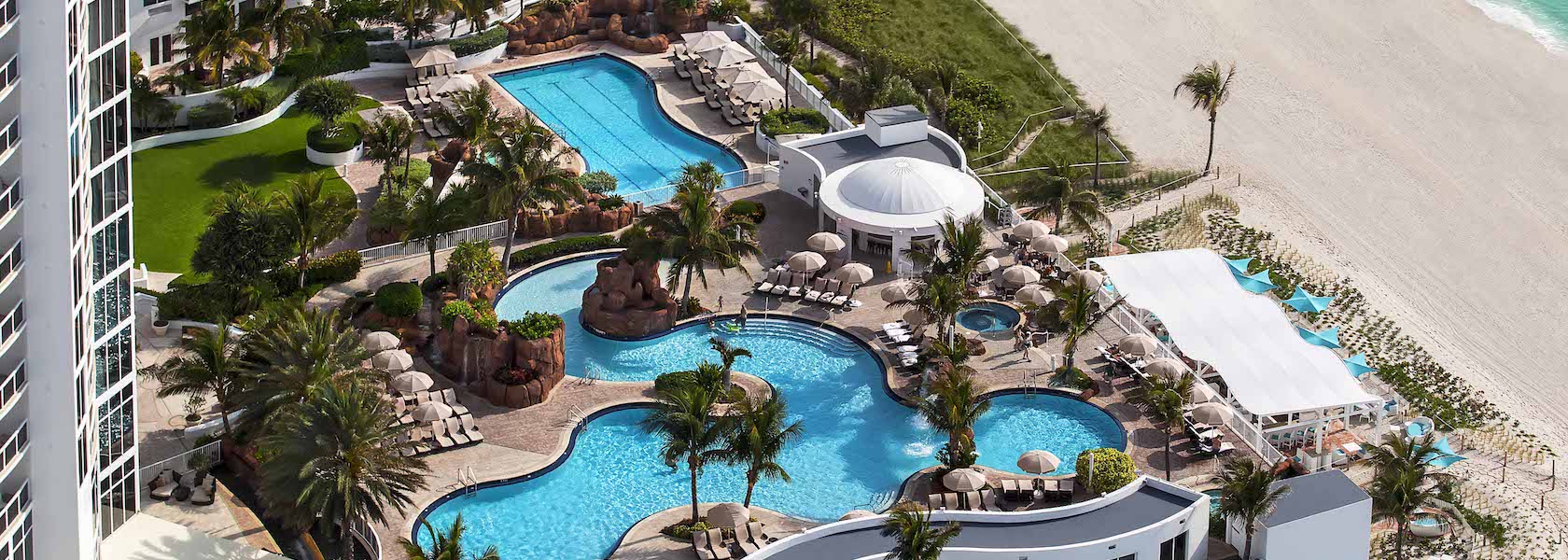 Pool and palm trees at Trump International Beach Resort